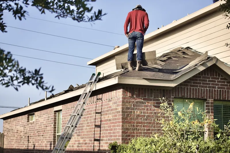 Professional roofer working on a residential roof in Cedar Grove